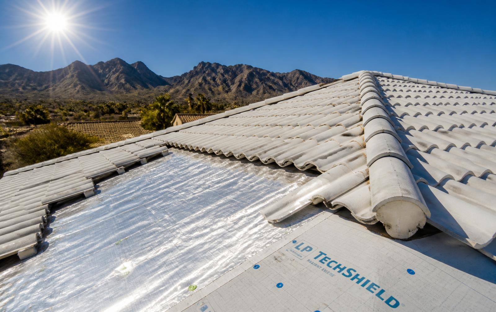 Reflective Arizona tile roof with radiant barrier underlayment under intense desert sunlight