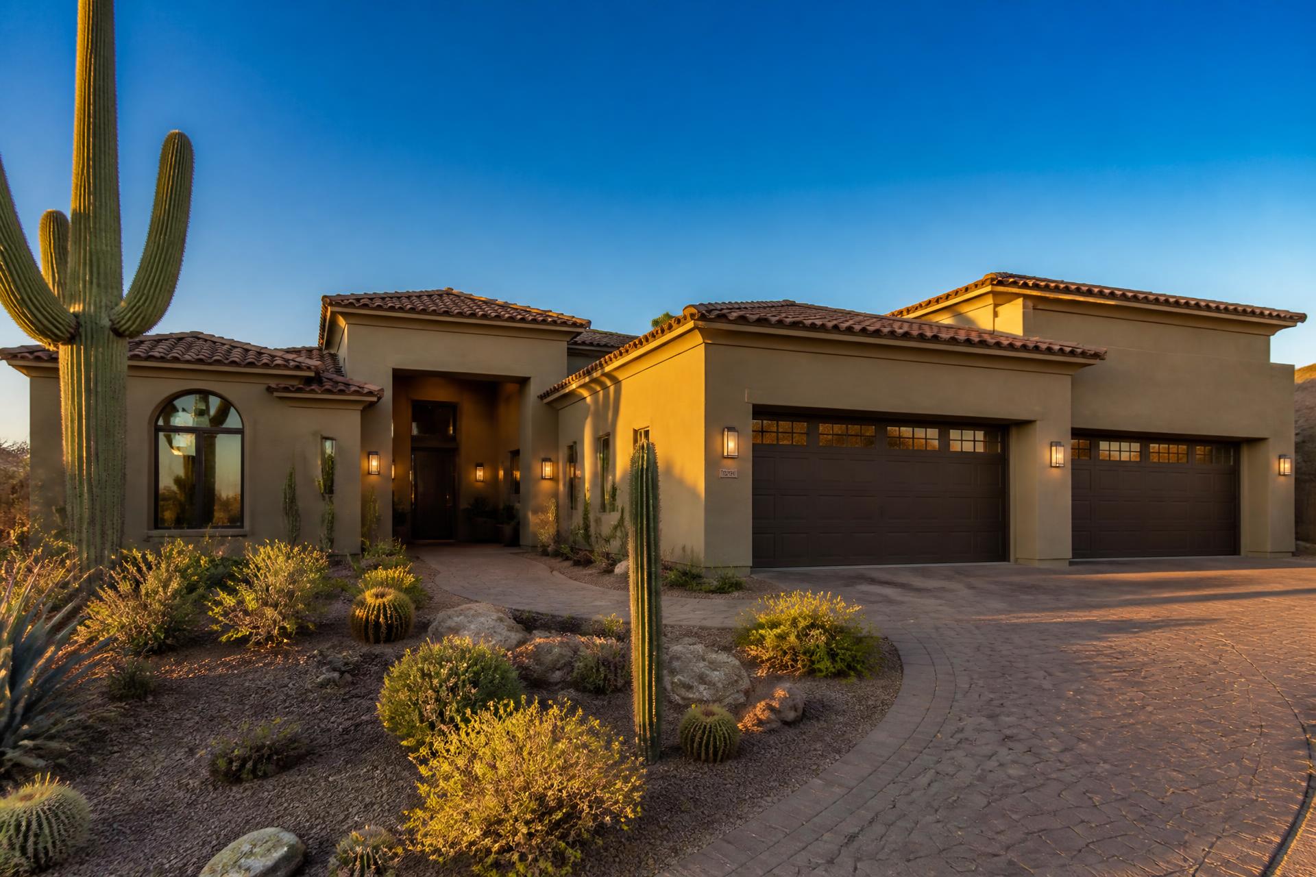 Modern Arizona home with tile roofing, stucco exterior, and desert landscaping at golden hour